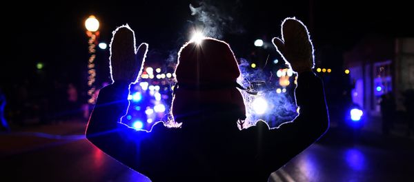This November 25, 2014 file photo shows a protester holding up her hands in front of a police car in Ferguson This November 25, 2014 file photo shows a protester holding up her hands in front of a police car in Ferguson - Sputnik International