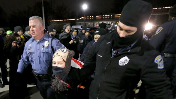 Ferguson, Mo., police officers take into custody a protester who was warned several times not to block the street outside the police station Ferguson, Mo., police officers take into custody a protester who was warned several times not to block the street outside the police station - Sputnik International