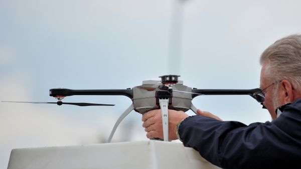 A technician prepares an unmanned surveillance drone at the Defence and Security Equipment International (DSEI) arms fair at the ExCeL centre in east London, on September 10, 2013 - Sputnik International