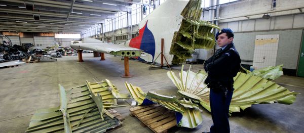 Dutch military police stand next to parts of the wreckage of the Malaysia Airlines Flight 17, displayed in a hangar at Gilze-Rijen airbase, Netherlands, Tuesday, March 3, 2015 Dutch military police stand next to parts of the wreckage of the Malaysia Airlines Flight 17, displayed in a hangar at Gilze-Rijen airbase, Netherlands, Tuesday, March 3, 2015 - Sputnik International
