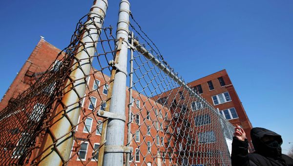 A protestor stands outside a police facility called Homan Square, demanding an investigation into a media report denied by police that the site functions as an off-the-books interrogation compound, in Chicago, Illinois, March 5, 2015 - Sputnik International