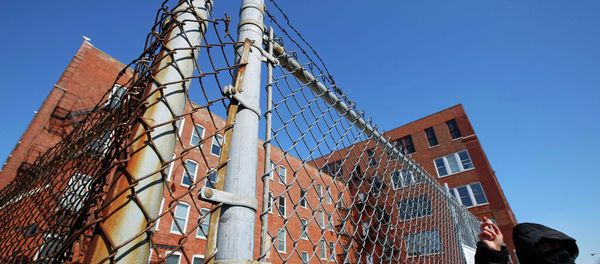 A protestor stands outside a police facility called Homan Square, demanding an investigation into a media report denied by police that the site functions as an off-the-books interrogation compound, in Chicago, Illinois, March 5, 2015 A protestor stands outside a police facility called Homan Square, demanding an investigation into a media report denied by police that the site functions as an off-the-books interrogation compound, in Chicago, Illinois, March 5, 2015 - Sputnik International