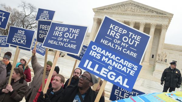 Protestors hold placards challenging Obamacare outside of the US Supreme Court on March 4, 2015 in Washington, DC Protestors hold placards challenging Obamacare outside of the US Supreme Court on March 4, 2015 in Washington, DC - Sputnik International