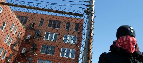 A protestor stands outside a police facility called Homan Square, demanding an investigation into a media report denied by police that the site functions as an off-the-books interrogation compound, in Chicago, Illinois, March 5, 2015 - Sputnik International