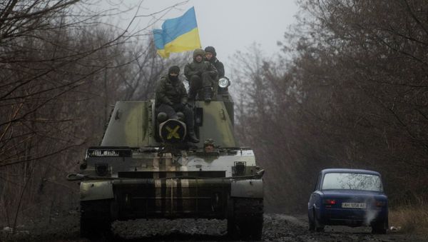 Ukrainian servicemen ride atop an armored vehicle with a Ukrainian flag, on the outskirts of Donetsk, Ukraine Ukrainian servicemen ride atop an armored vehicle with a Ukrainian flag, on the outskirts of Donetsk, Ukraine - Sputnik International