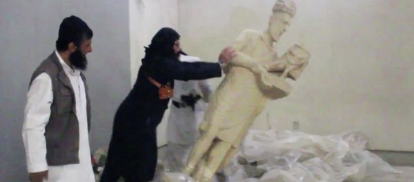 In this image made from video posted on a social media account affiliated with the Islamic State group on Thursday, Feb. 26, 2015, which has been verified and is consistent with other AP reporting, a militant topples an ancient artifact in the Ninevah Museum in Mosul, Iraq In this image made from video posted on a social media account affiliated with the Islamic State group on Thursday, Feb. 26, 2015, which has been verified and is consistent with other AP reporting, a militant topples an ancient artifact in the Ninevah Museum in Mosul, Iraq - Sputnik International
