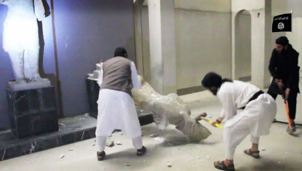 In this image made from video posted on a social media account affiliated with the Islamic State group on Thursday, Feb. 26, 2015, which has been verified and is consistent with other AP reporting, militants take sledgehammers to an ancient artifact in the Ninevah Museum in Mosul, Iraq. - Sputnik International