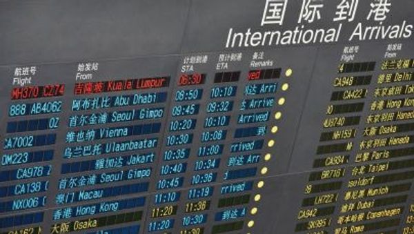 A message is seen to show the delayed arrival of the missing Malaysian flight on an electronic board at the Beijing Capital International Airport in Beijing, capital of China - Sputnik International