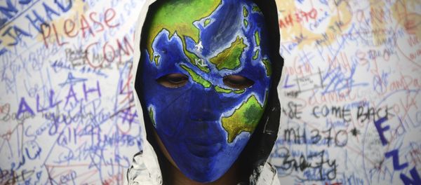 Аn unidentified woman wearing a mask depicting the flight of the missing Malaysia Airline, MH370, poses in front of the wall of hope at Kuala Lumpur International Airport in Sepang, Malaysia - Sputnik International