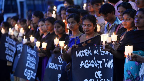 Women hold placards during a silent protest titled Women in Black for Peace on the eve of International Women's Day in Bangalore Women hold placards during a silent protest titled Women in Black for Peace on the eve of International Women's Day in Bangalore - Sputnik International