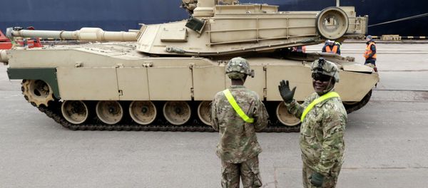 A U.S. soldier greets the media as custom officers inspect an Abrams main battle tank, for U.S. troops deployed in the Baltics as part of NATO's Operation Atlantic Resolve A U.S. soldier greets the media as custom officers inspect an Abrams main battle tank, for U.S. troops deployed in the Baltics as part of NATO's Operation Atlantic Resolve - Sputnik International