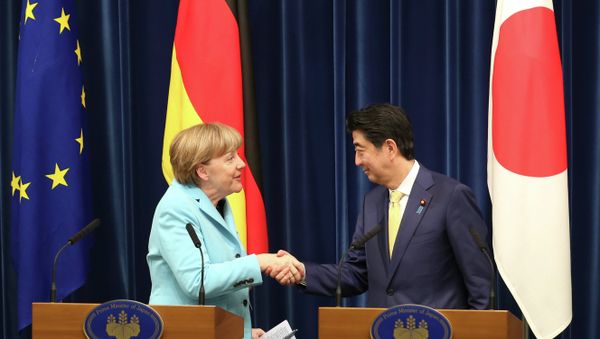 German Chancellor Angela Merkel, left, shakes hands with Japanese Prime Minister Shinzo Abe during a joint press conference at Abe's official residence in Tokyo German Chancellor Angela Merkel, left, shakes hands with Japanese Prime Minister Shinzo Abe during a joint press conference at Abe's official residence in Tokyo - Sputnik International