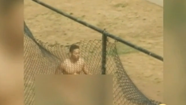 The caller had said a man was “acting deranged, knocking on doors, and crawling around in the ground naked.” The caller had said a man was “acting deranged, knocking on doors, and crawling around in the ground naked.” - Sputnik International