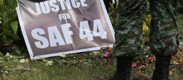 A Philippine police commando stands near a poster calling for justice for 44 commandos killed in a clash with Muslim rebels in January. A Philippine police commando stands near a poster calling for justice for 44 commandos killed in a clash with Muslim rebels in January. - Sputnik International