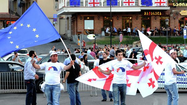 People wave the flags of Georgia (R) and the European Union (L) during celebrations for the signing of an association agreement with the EU in Tbilisi on June 27, 2014 People wave the flags of Georgia (R) and the European Union (L) during celebrations for the signing of an association agreement with the EU in Tbilisi on June 27, 2014 - Sputnik International
