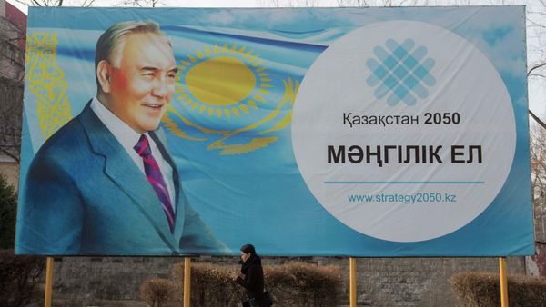 A woman walks past a poster depicting Kazakhstan's President Nursultan Nazarbayev in Almaty February 16, 2015 A woman walks past a poster depicting Kazakhstan's President Nursultan Nazarbayev in Almaty February 16, 2015 - Sputnik International