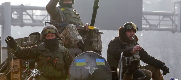 Ukrainian servicemen ride atop an armoured personnel carrier (APC), as they return from the frontline in eastern Ukraine, in Kiev March 11, 2015 Ukrainian servicemen ride atop an armoured personnel carrier (APC), as they return from the frontline in eastern Ukraine, in Kiev March 11, 2015 - Sputnik International