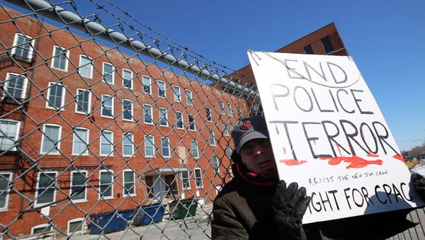 A protestor stands outside a police facility called Homan Square, demanding an investigation into a media report denied by police that the site functions as an off-the-books interrogation compound, in Chicago, Illinois, March 5, 2015 - Sputnik International