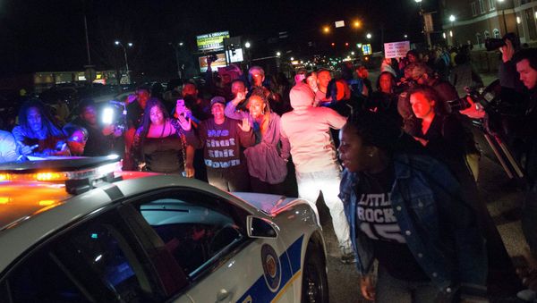 Protestors block a police vehicle from entering the City of Ferguson Police Department and Municipal Court parking lot in Ferguson Missouri, March 11, 2015 Protestors block a police vehicle from entering the City of Ferguson Police Department and Municipal Court parking lot in Ferguson Missouri, March 11, 2015 - Sputnik International