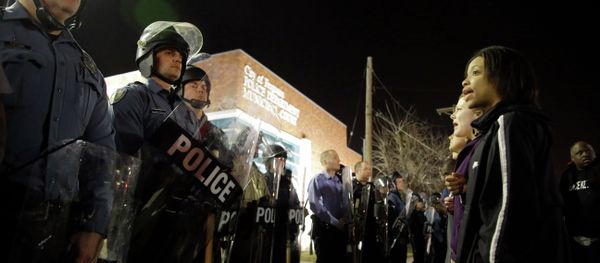Police and protesters square off outside the Ferguson Police Department, Wednesday, March 11, 2015, in Ferguson, Mo - Sputnik International