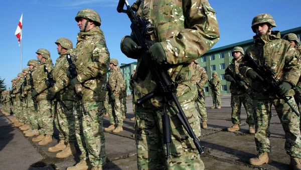 Servicemen from the 23rd battalion of the second infantry brigade of the Georgian Armed Forces stand at attention during a send-off ceremony at the Vaziani military base outside Tbilisi, Tuesday, Dec. 9, 2014 - Sputnik International