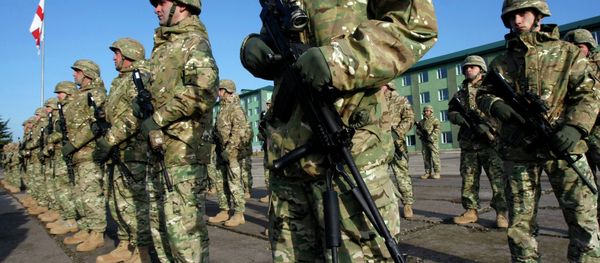 Servicemen from the 23rd battalion of the second infantry brigade of the Georgian Armed Forces stand at attention during a send-off ceremony at the Vaziani military base outside Tbilisi, Tuesday, Dec. 9, 2014 - Sputnik International