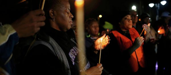 Protestors hold a candle-light vigil outside the Ferguson Police Department in Ferguson, Missouri, March 12, 2015 Protestors hold a candle-light vigil outside the Ferguson Police Department in Ferguson, Missouri, March 12, 2015 - Sputnik International