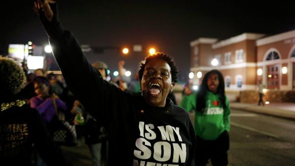A protestor shouts during a demonstration outside the Ferguson Police Department in Ferguson, Missouri, March 12, 2015 A protestor shouts during a demonstration outside the Ferguson Police Department in Ferguson, Missouri, March 12, 2015 - Sputnik International