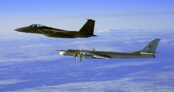 Tu-95 strategic bomber, escorted by a US Air Force F-15C Eagle off the coast of Alaska, 2006. Tu-95 strategic bomber, escorted by a US Air Force F-15C Eagle off the coast of Alaska, 2006. - Sputnik International