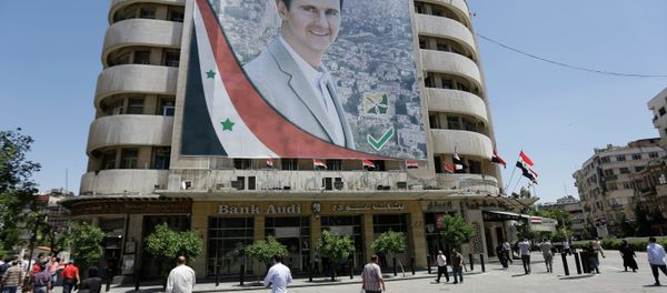 Syrians walk past a giant campaign billboard of Syrian President Bashar al-Assad on June 1, 2014 in the capital Damascus Syrians walk past a giant campaign billboard of Syrian President Bashar al-Assad on June 1, 2014 in the capital Damascus - Sputnik International