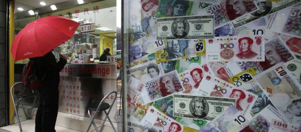 A man stands beside a collage of copies of Chinese RMB, U.S. dollar and other foreign bills at a money exchange store in Hong Kong Thursday, April 15, 2010 A man stands beside a collage of copies of Chinese RMB, U.S. dollar and other foreign bills at a money exchange store in Hong Kong Thursday, April 15, 2010 - Sputnik International