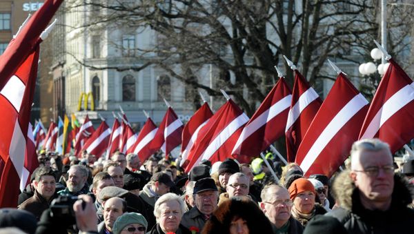 People carry Latvian flags at the march in Riga, Latvia People carry Latvian flags at the march in Riga, Latvia - Sputnik International
