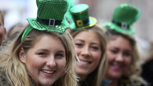 Three women take part in the St Patrick's Day parade through central London. - Sputnik International