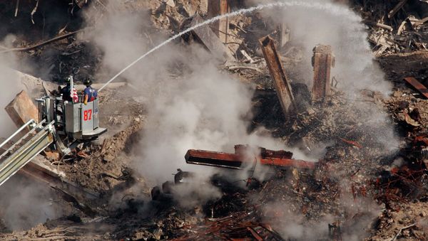 Firefighters hose down hot spots on the rubble of the World Trade Center in New York, Friday, Oct. 12, 2001 as work continues to remove debris and victims of the Sept. 11 attack. Officials say 4,776 people are still missing in the wreckage of the twin towers; 442 people have been confirmed dead and 384 of those have been identified. - Sputnik International