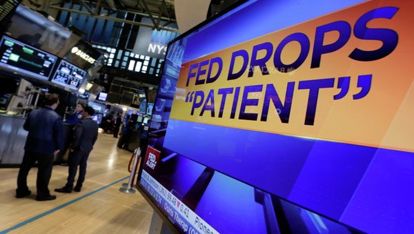 A screen on the floor of the New York Stock Exchange shows the decision of the Federal Reserve to drop the word patient from its Federal Open Market Committee statement. - Sputnik International