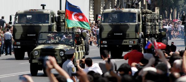 Military vehicles make their way down a road during a military parade marking Armed Forces Day in Baku, Azerbaijan, in 2011. - Sputnik International