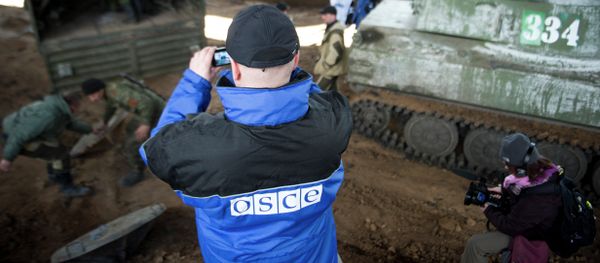 An international monitor of the Organization for Security and Co-operation in Europe (OSCE) shoots video - Sputnik International
