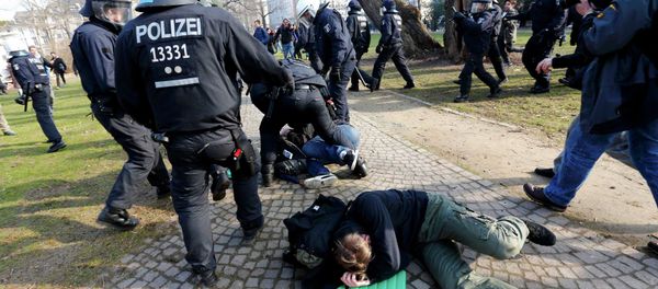 Policemen detain members of 'Blockupy' anti-capitalist movement near the European Central Bank (ECB) building before the official opening of its new headquarters in Frankfurt March 18, 2015 Policemen detain members of 'Blockupy' anti-capitalist movement near the European Central Bank (ECB) building before the official opening of its new headquarters in Frankfurt March 18, 2015 - Sputnik International