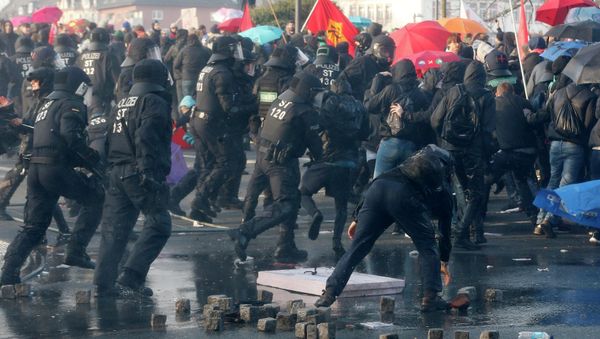 Police chase demonstrators after they threw stones Wednesday, March 18, 2015 in Frankfurt, Germany Police chase demonstrators after they threw stones Wednesday, March 18, 2015 in Frankfurt, Germany - Sputnik International