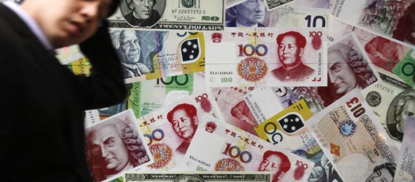 A man walks past a collage of copies of Chinese RMB, U.S. dollar and other foreign bills at a money exchange store in Hong Kong Thursday, April 15, 2010 A man walks past a collage of copies of Chinese RMB, U.S. dollar and other foreign bills at a money exchange store in Hong Kong Thursday, April 15, 2010 - Sputnik International