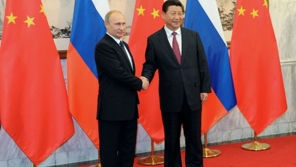 Russian President Vladimir Putin, left, shakes hands with Chinese President Xi Jinping prior to the Asia-Pacific Economic Cooperation (APEC) forum in Beijing Russian President Vladimir Putin, left, shakes hands with Chinese President Xi Jinping prior to the Asia-Pacific Economic Cooperation (APEC) forum in Beijing - Sputnik International