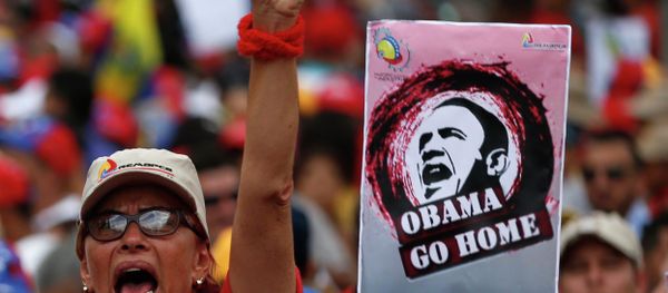 A supporter of Venezuela's President Nicolas Maduro shouts next to a placard depicting US President Barack Obama during a rally against imperialism, in Caracas March 15, 2015 - Sputnik International