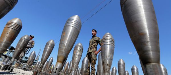 A member of the Iraqi security forces stands between Islamic State ammunition being displayed in al-Alam Salahuddin province March 17, 2015 - Sputnik International