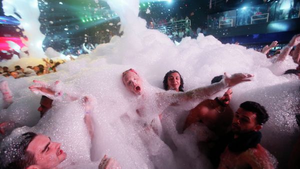 Partygoers dance in foam at The City nightclub in the Caribbean resort city of Cancun, Mexico, early Monday, March 16, 2015 - Sputnik International