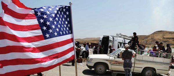 US flag waves while displaced Iraqis from the Yazidi community cross the Syria-Iraq border on Feeshkhabour bridge over Tigris River at Feeshkhabour border point, northern Iraq - Sputnik International