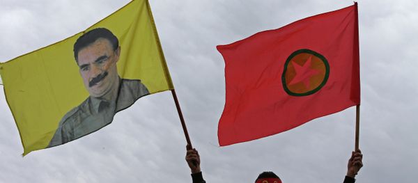 A Kurdish man waves a flag of the Kurdistan Workers' Party, known as PKK, right, and a flag with a portrait of the jailed Turkish Kurdish guerrilla leader Abdullah Ocalan, left, during a demonstration demanding his release, in Beirut, Lebanon - Sputnik International