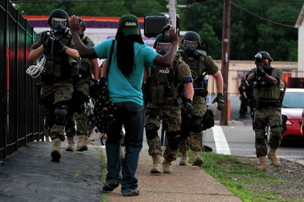 In this Aug. 11, 2014, file photo, police wearing riot gear walk toward a man with his hands raised Monday, Aug. 11, 2014, in Ferguson In this Aug. 11, 2014, file photo, police wearing riot gear walk toward a man with his hands raised Monday, Aug. 11, 2014, in Ferguson - Sputnik International