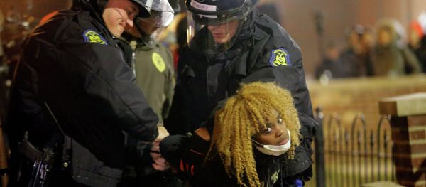 Police officers take a protester into custody Tuesday, Nov. 25, 2014, in Ferguson, Mo. Police officers take a protester into custody Tuesday, Nov. 25, 2014, in Ferguson, Mo. - Sputnik International