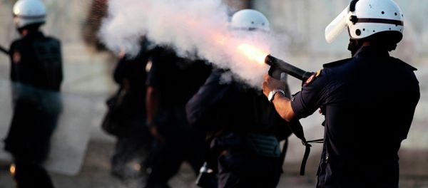 Riot police fire tear gas as they chase Bahraini anti-government protesters throwing stones and petrol bombs on the outskirts of the capital of Manama, Bahrain Riot police fire tear gas as they chase Bahraini anti-government protesters throwing stones and petrol bombs on the outskirts of the capital of Manama, Bahrain - Sputnik International