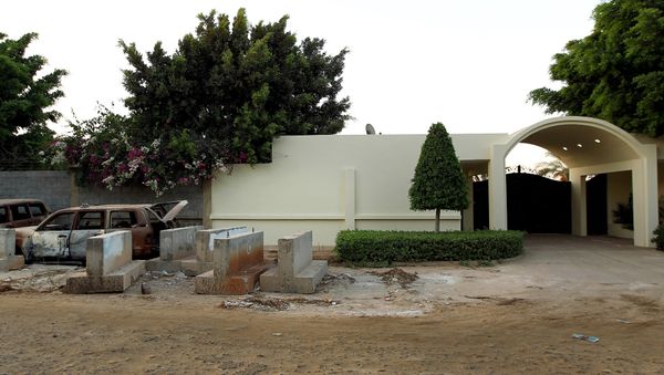 A picture taken on September 10, 2013 shows the wreckage of burnt cars outside the main gate of the US consulate in Benghazi on the eve of the anniversary of the 2012 attack on the diplomatic mission that left four people dead, including the ambassador. - Sputnik International